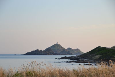 Scenic view of sea against clear sky during sunset