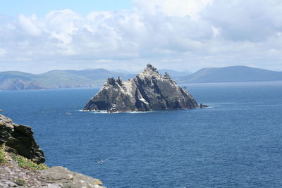 Scenic view of sea and mountains against sky