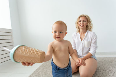 Mother playing with daughter at home