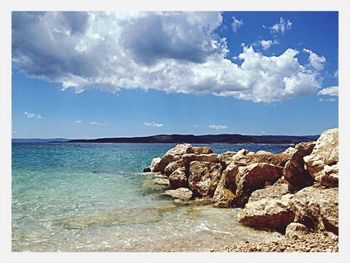 Scenic view of sea against cloudy sky