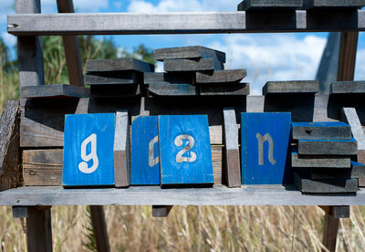 Close-up of text on wooden railing