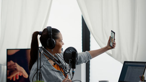 Side view of woman using mobile phone