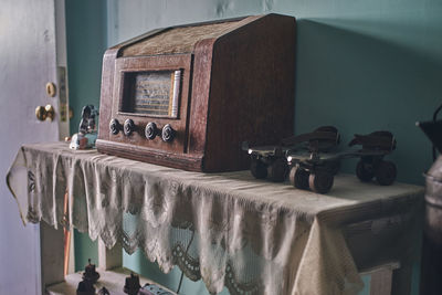 Old radio, next to metal skates of the same era