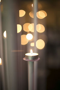 Close-up of illuminated tea light candles