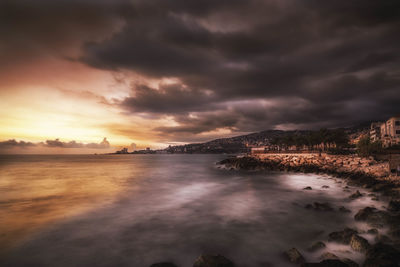 Scenic view of sea against storm clouds