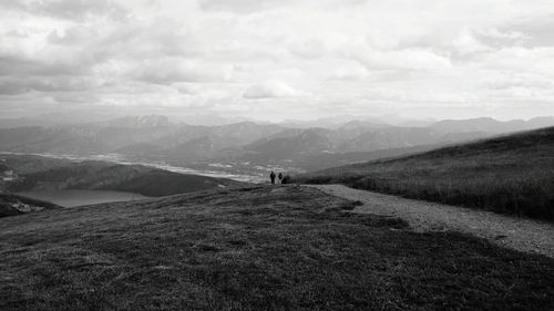 People on mountain with millstatter see against cloudy sky