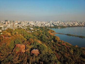 High angle view of buildings and trees against sky