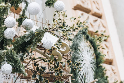 Christmas outdoor building decorations. white baubles and pine branche