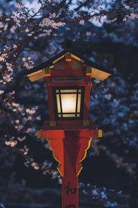 Low angle view of illuminated street light against sky