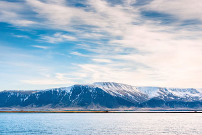 Scenic view of snow covered mountains against sky