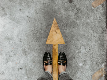 Low section of person standing on road