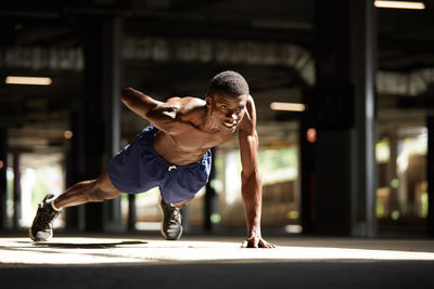 Portrait of young woman exercising in gym