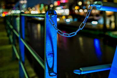 Close-up of illuminated lighting equipment hanging on railing