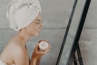 Midsection of woman holding coffee cup