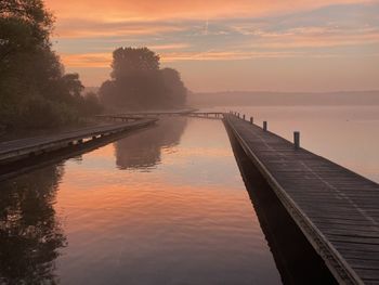 Scenic view of lake against sky during sunset