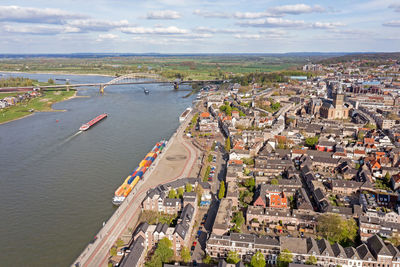 High angle view of cityscape by sea against sky