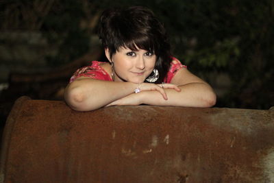 Portrait of young woman sitting outdoors