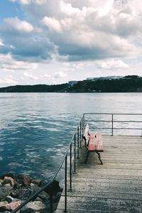 Pier over lake against sky