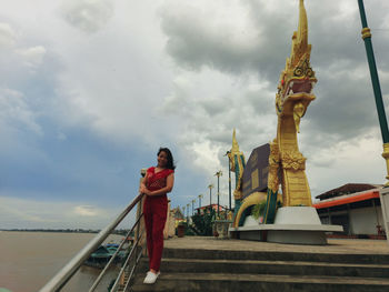 Statue of temple against cloudy sky