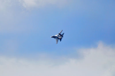 Low angle view of airplane flying in sky