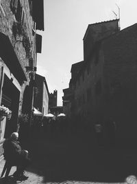 Rear view of man walking on street in city