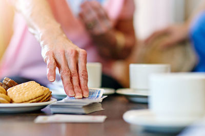 Midsection of man preparing food on table