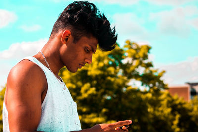 Close-up of young man against sky