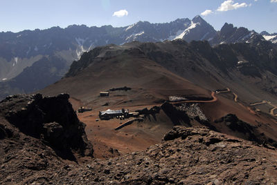 Aerial view of land and mountains against sky