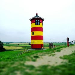 Lighthouse on grassy field