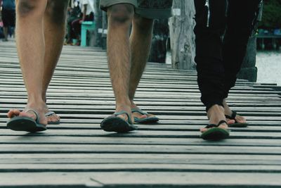 Low section of people standing on tiled floor