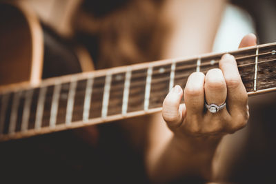 Close-up of hand playing guitar