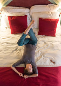 High angle view of woman lying on bed at home