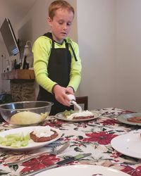 Boy standing on table at home