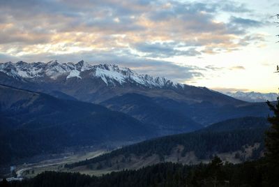 Scenic view of mountains against cloudy sky