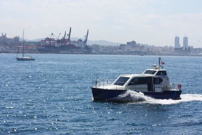 Ship sailing in sea against sky