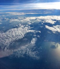 Scenic view of mountain range against cloudy sky