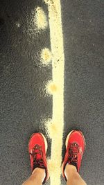 Low section of man standing on road