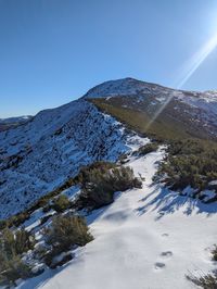 Scenic view of snowcapped mountains against clear sky