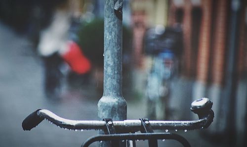 Close-up of bicycle on railing by street