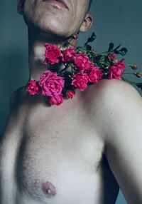 Close-up of woman with pink flower