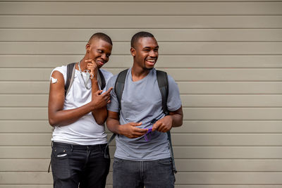 Afro men friends vaccinated showing his arm