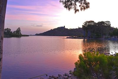 Scenic view of lake against sky at sunset