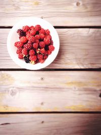 Directly above of berries in plate on table