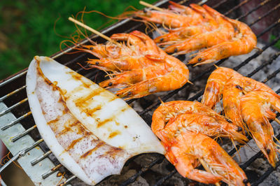 High angle view of fish on barbecue grill