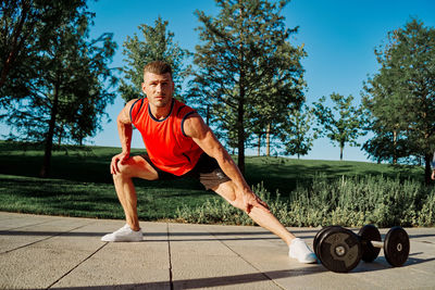 Full length of man exercising in gym