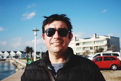 Portrait of man wearing sunglasses against sky