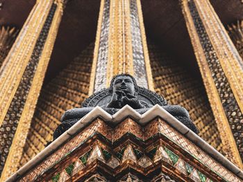 Low angle view of statue against building