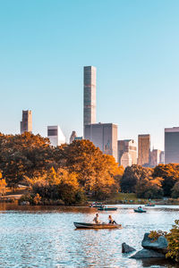 River and buildings against clear sky