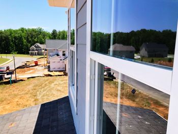 Buildings seen through glass window against clear sky