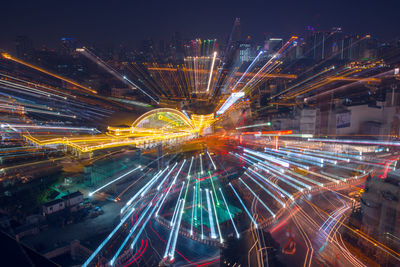 High angle view of illuminated cityscape against sky at night